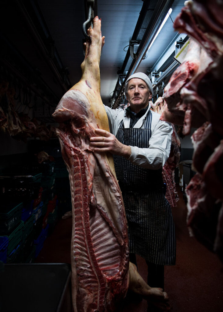 Pat McLoughlin butcher with meat carcass